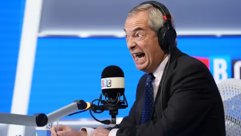 PA Wire Reform UK leader Nigel Farage during an appearance on LBC's Nick Ferrari at Breakfast show, at the Global Studios in London on 24 September, 2025. He wears a dark jacket, blue tie with light blue dots and a white shirt with light blue checks.
