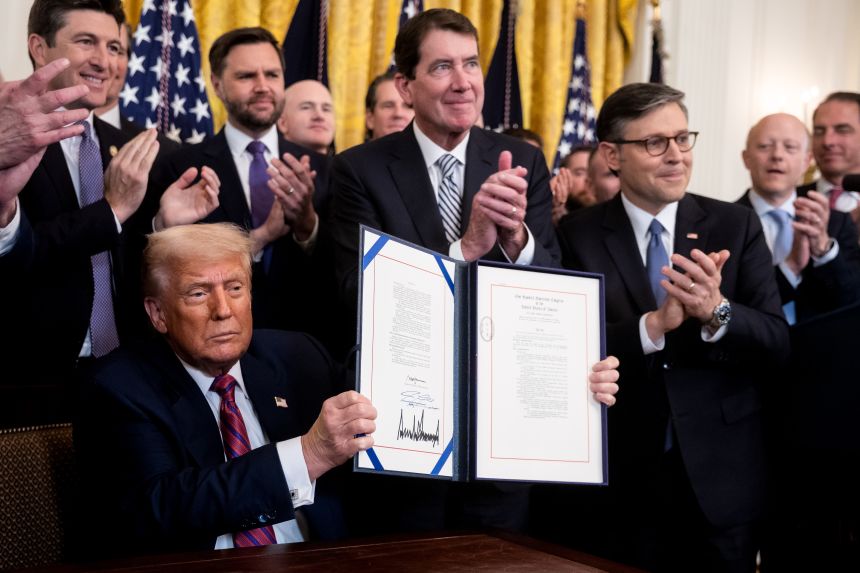 US President Donald Trump displays the signed bill during a signing ceremony for the GENIUS Act in the East Room of the White House in Washington, DC, on July 18, 2025. Trump signed the first federal bill to regulate stablecoins, hailing it as a "giant step to cement American dominance of global finance and crypto technology" and delivering a major victory for the digital asset industry.